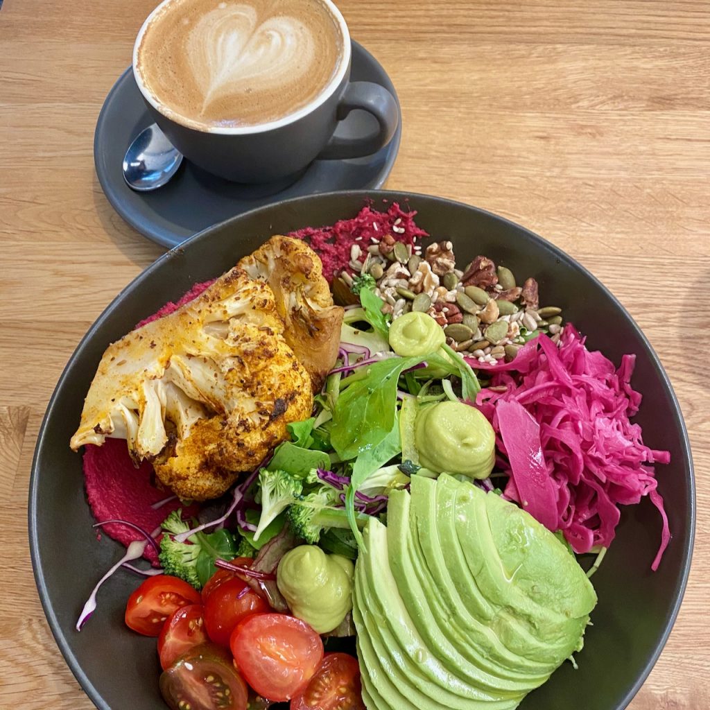 Colourful vegan brunch bowl with coffee