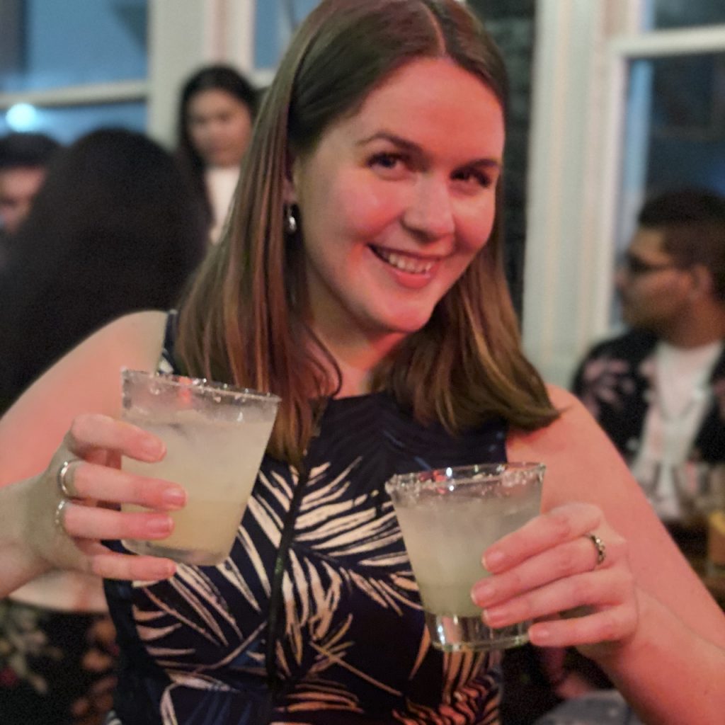 Woman with two glasses of margarita