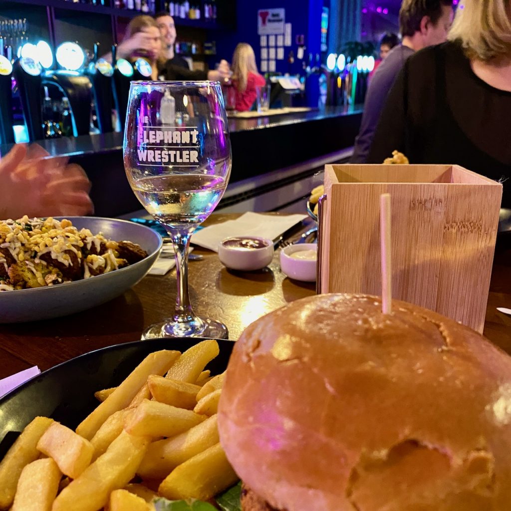 Burger and fries at a busy pub