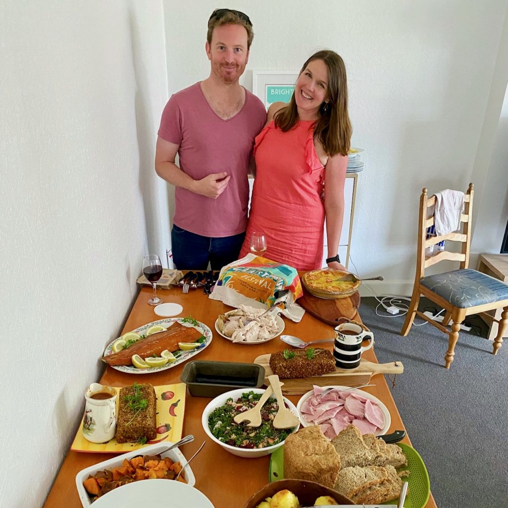 Smiling people with table of food