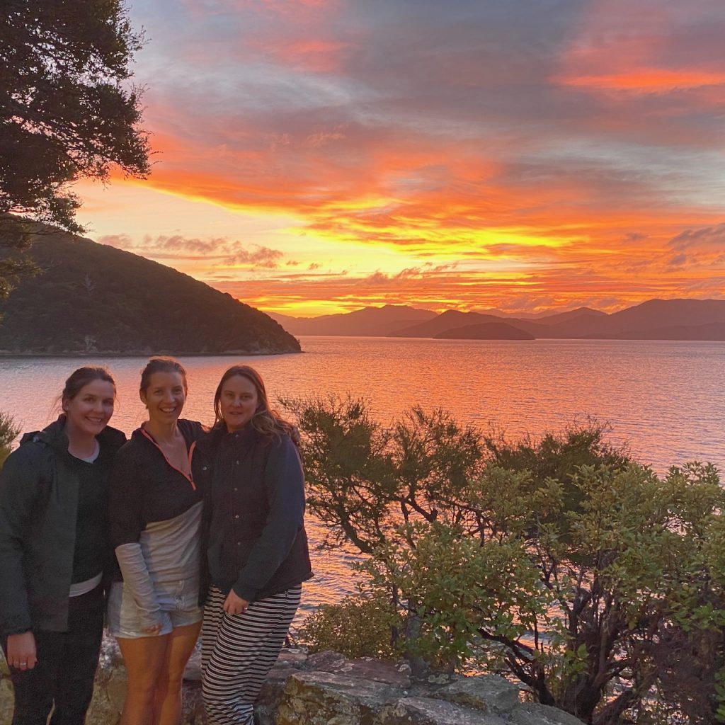 Women in front of orange sunset