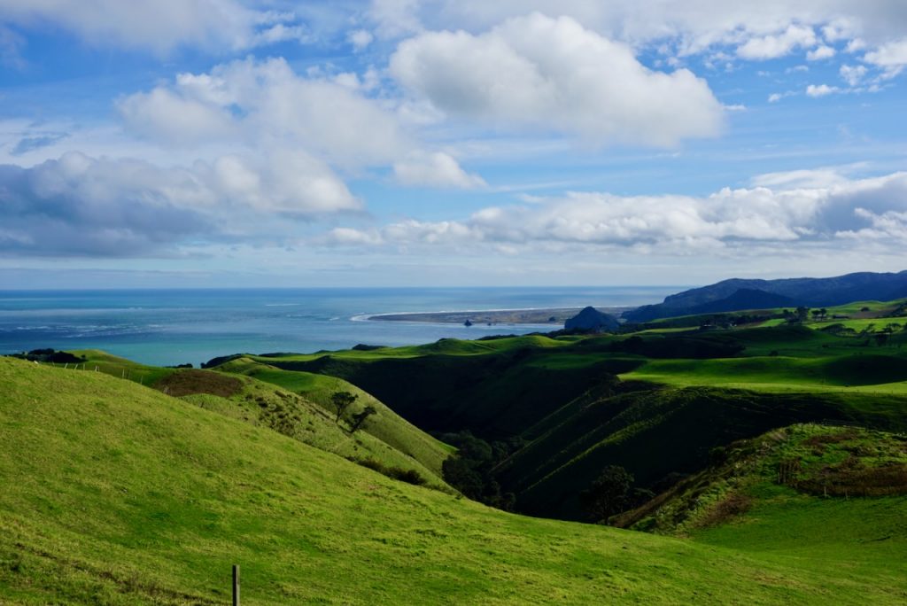 Green hills with blue sea in distance